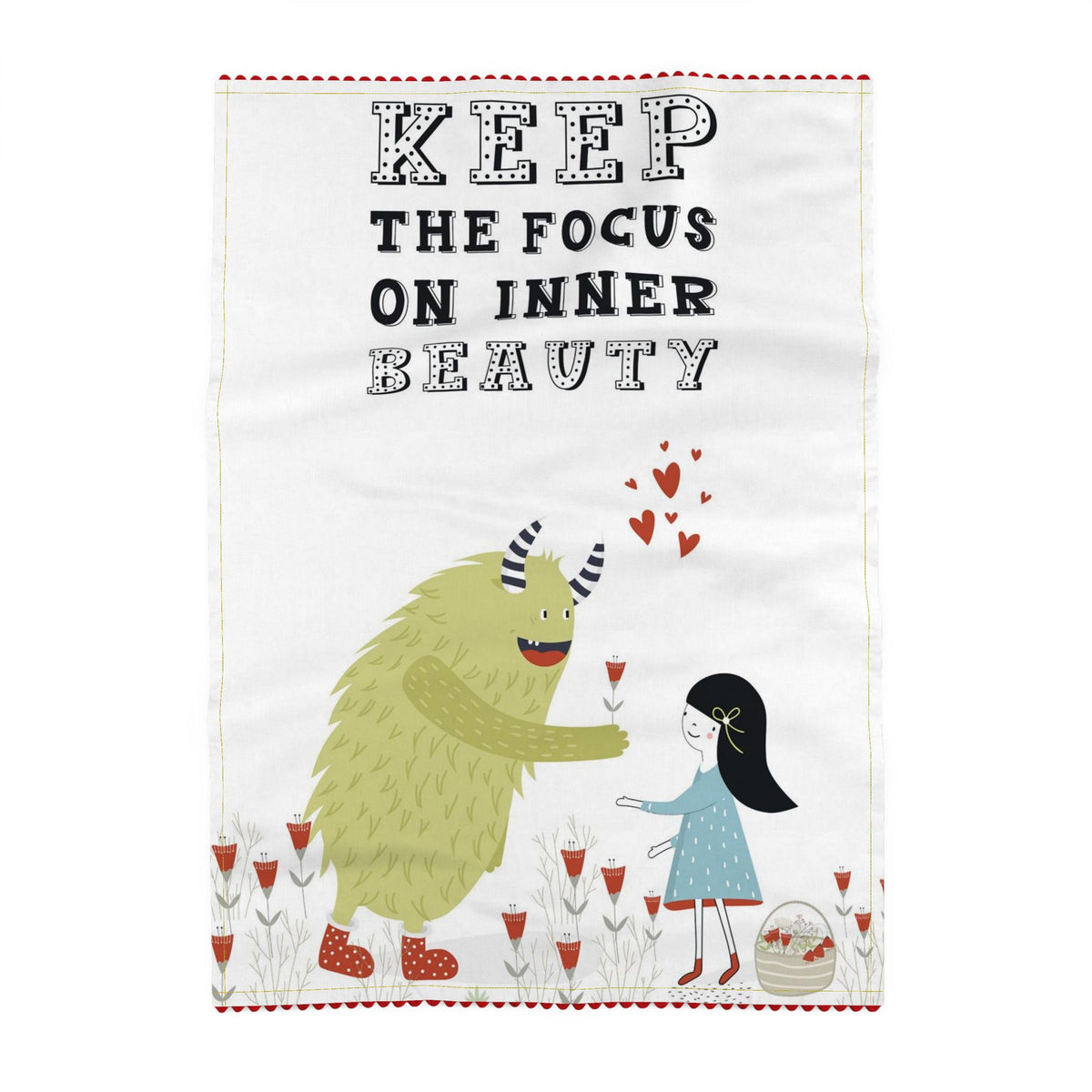 Tea towel reading Keep the focus on inner beauty, and little red heart shapes above a shaggy green horned monster offering a red flower to a girl in a blue dress among red flowers. Off-white ground